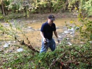 Charles Wagner cleaning the bank of Herring Run Creek