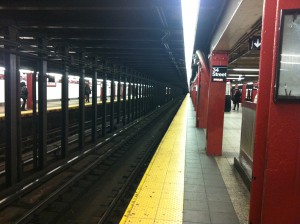 We wait for a ride on the New York City subway system